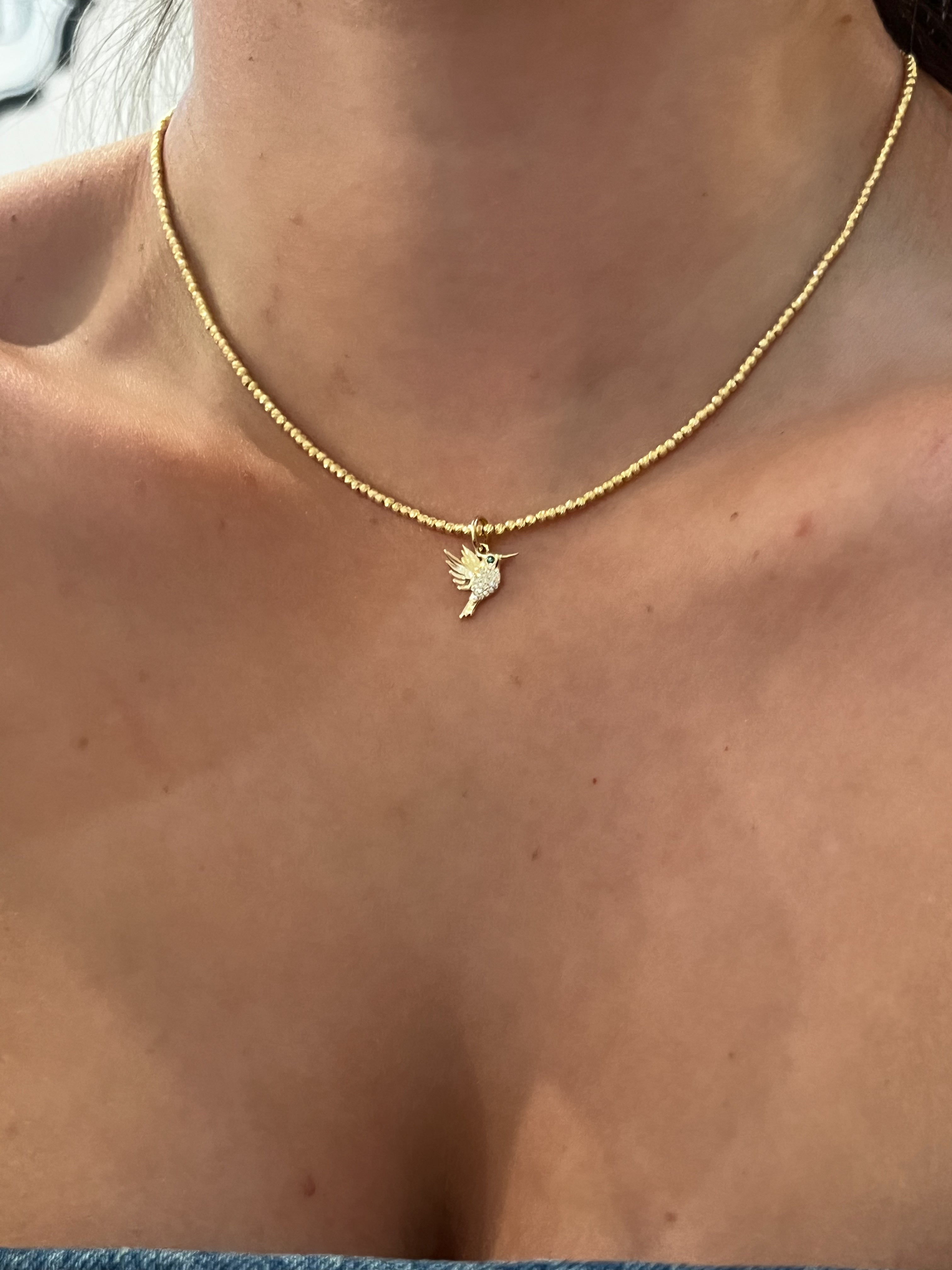 WD1825 14kt gold Pave set diamond Small humming bird with emerald eye pendant