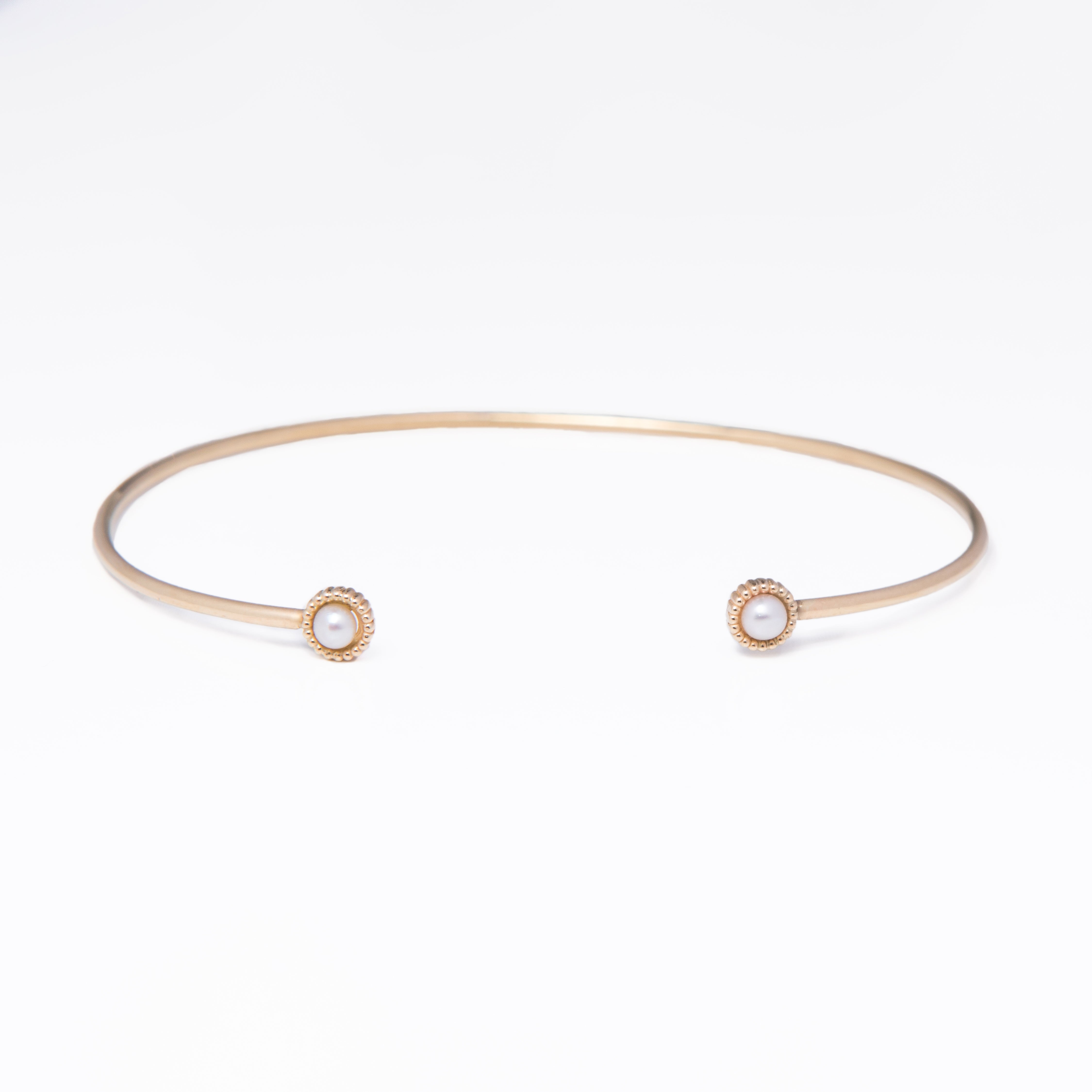 WD139-PE, 14kt gold thin cuff bracelet with 3mm bezel pearl detail on each end